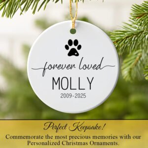 Personalized Christmas ornament with paw print and text 'forever loved  against a green foliage background.