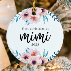 Decorative ornament with floral design and text 'first christmas as mimi 2023' on a Christmas tree.
