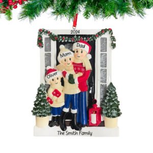 A personalized Christmas ornament featuring a family of three, with the ability to customize the names and the year. The ornament has a festive design with holiday clothing and a Christmas tree in the background.